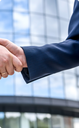 Close-up of two hands shaking, representing EG’s trusted partnerships with global suppliers.